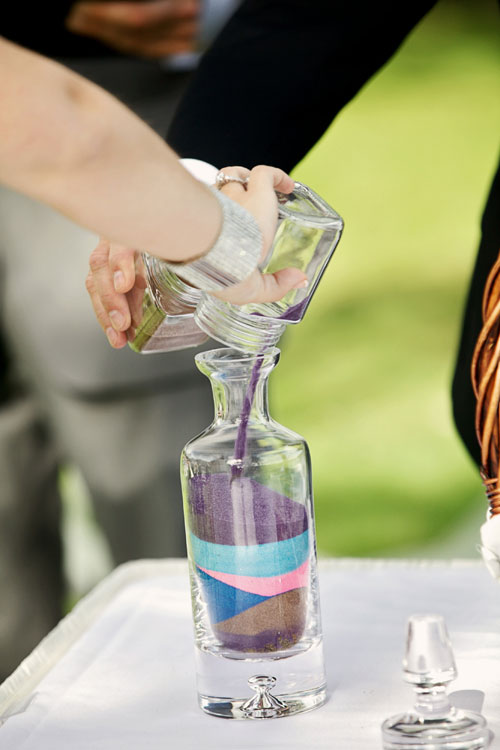 bride and groom pouring sand in the unity sand wedding ritual ceremony