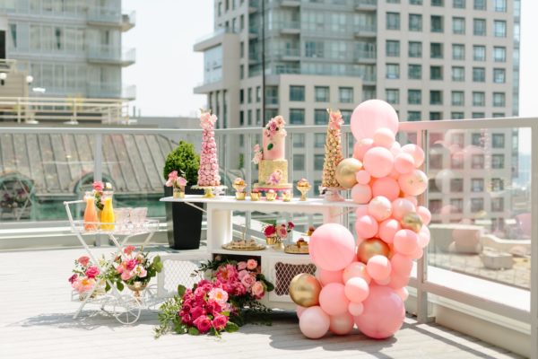 beautiful girly bridal shower with pink balloon arches, roof top bridal shower