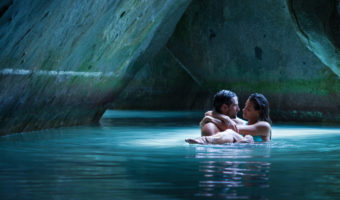 couple embrace in water inside cave at the Baths Virgin Gorda honeymoons