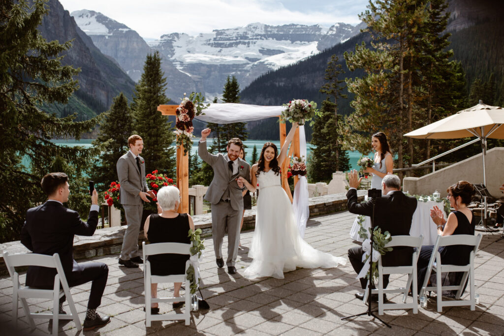 bride and groom celebrating after saying their vows at Lake Louise Canada elopement wedding