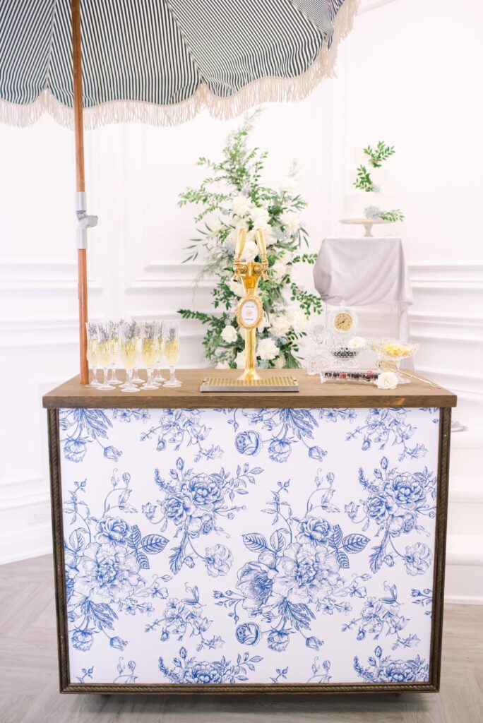 Blue and white floral bar with umbrella, perfect for a tropical drink.