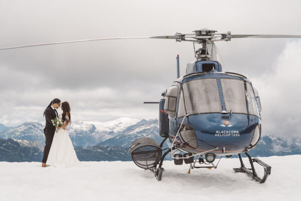 bride and groom helicopter hugging