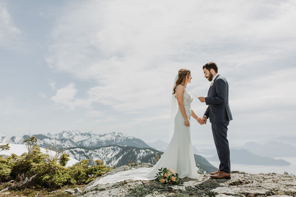 bride and groom share vows on snow capped mountain top - Caledon Mountains