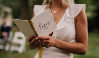 bride reading her wedding vows from a hers vow book