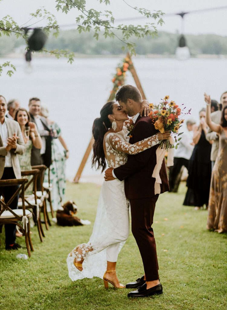 bride and groom kiss after wedding ceremony reading