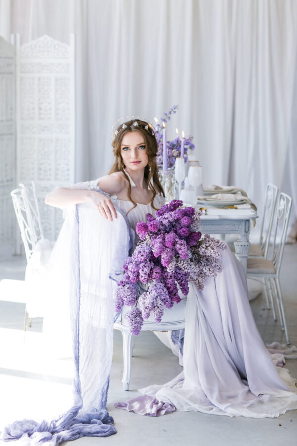 bride in a wedding dress with violet flowers