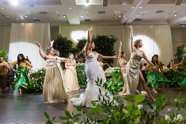 wedding bride is dancing with her maids of honour