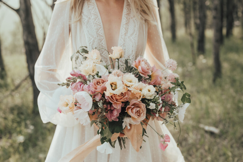 stunning bride at outdoor wedding holding a magical bouquet Fall wedding trend