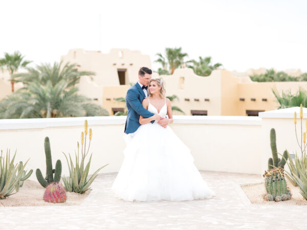 bride and groom pose for portrai in Mexico