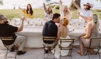bride and groom kissing at reception table during elopement