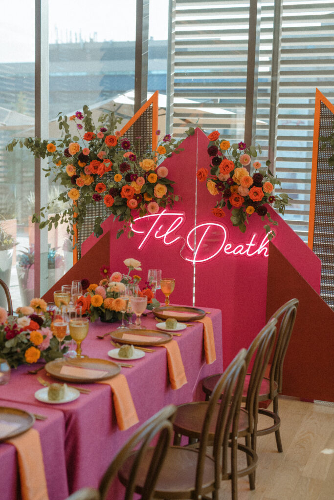 colourful wedding reception space with neon wedding sign