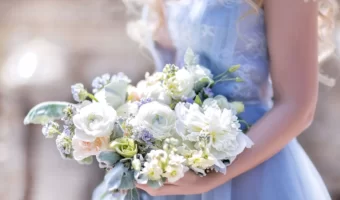 bride in blue wedding dress holding bouquet for bridal portrait