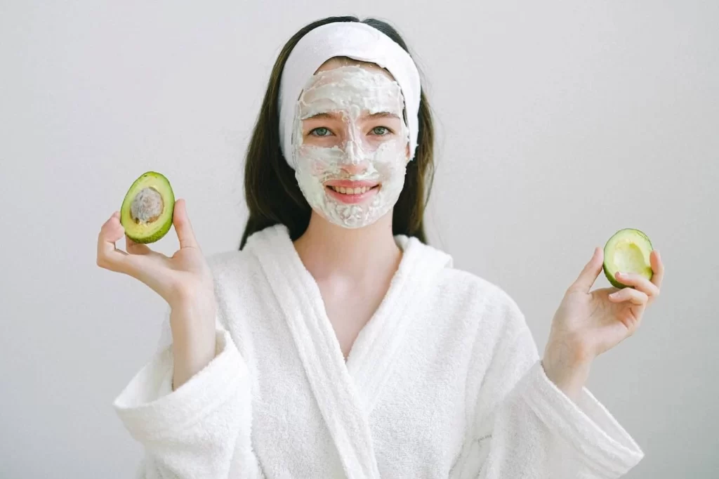bride in white robe wearing mask during beauty routine