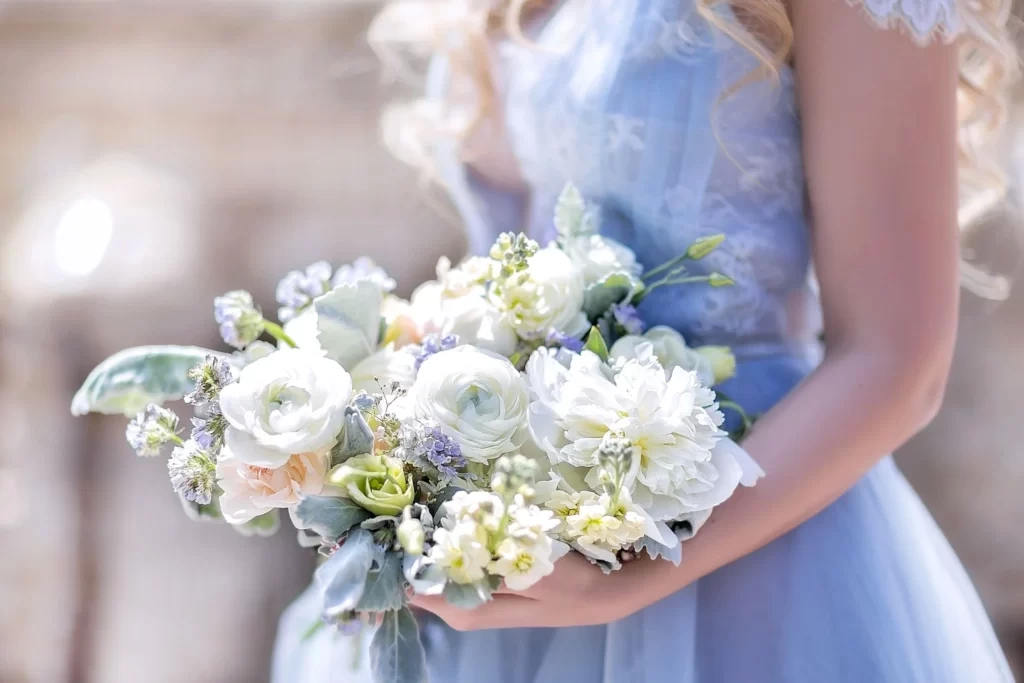 bride in blue wedding dress holding bouquet for bridal portrait