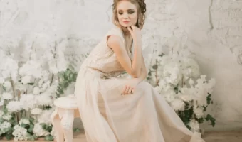 beautiful bride poses for portrait with vintage wedding decor