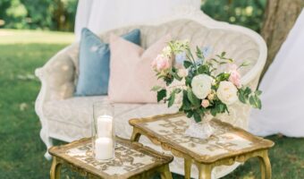 beautiful vintage couch seating at backyard wedding reception with drapery hanging from tree wedding lounge area for optimal guest experience