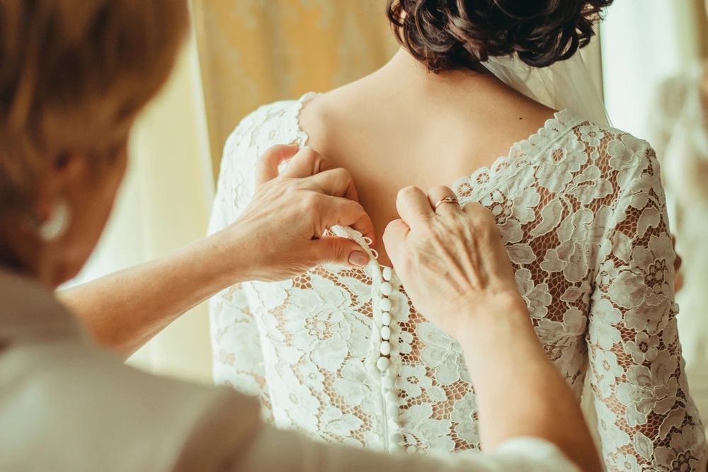 Mom dressing bride on her wedding day - a special wedding moment