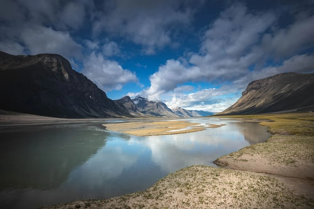 Beautiful landscape of Water front view of mountains on Akshayuk Pass, Buffin Island, Canada. Pond reflections