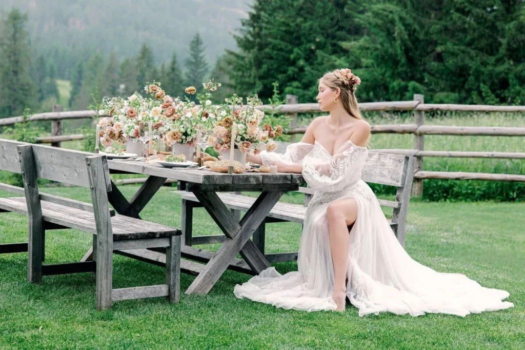 beautiful bride wearing wedding dress sleeves at summer outdoor wedding