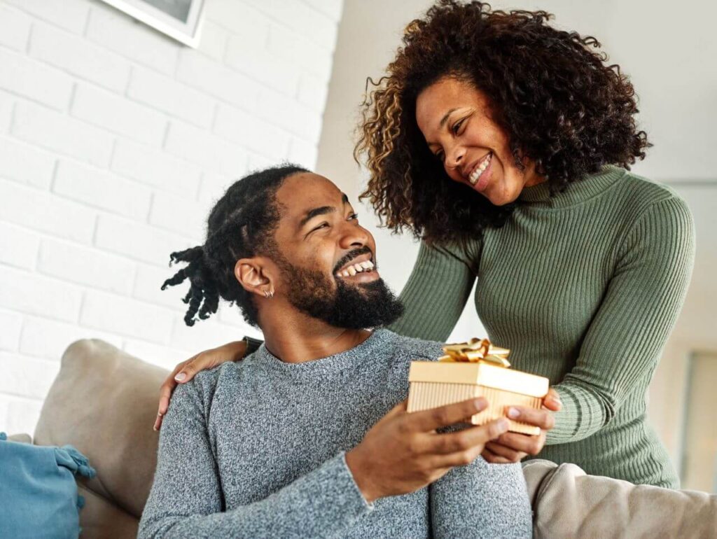 a couple giving present to each other