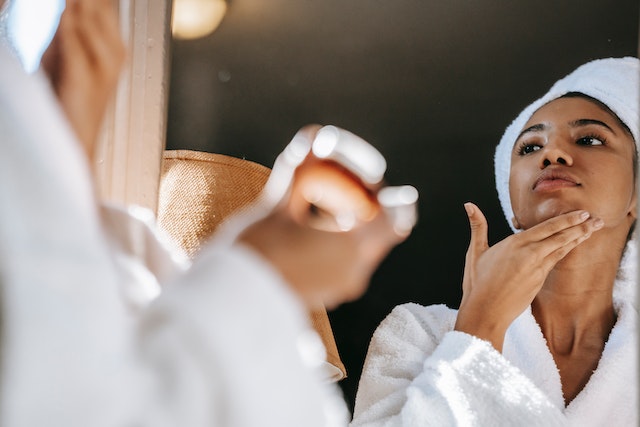 bride in bathroom applying skincare products