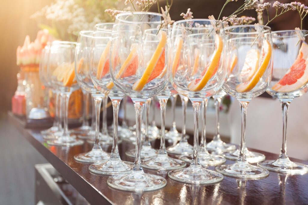 wedding stemware with grapefruit slices at wedding bar ready for guests to DIY their drinks
