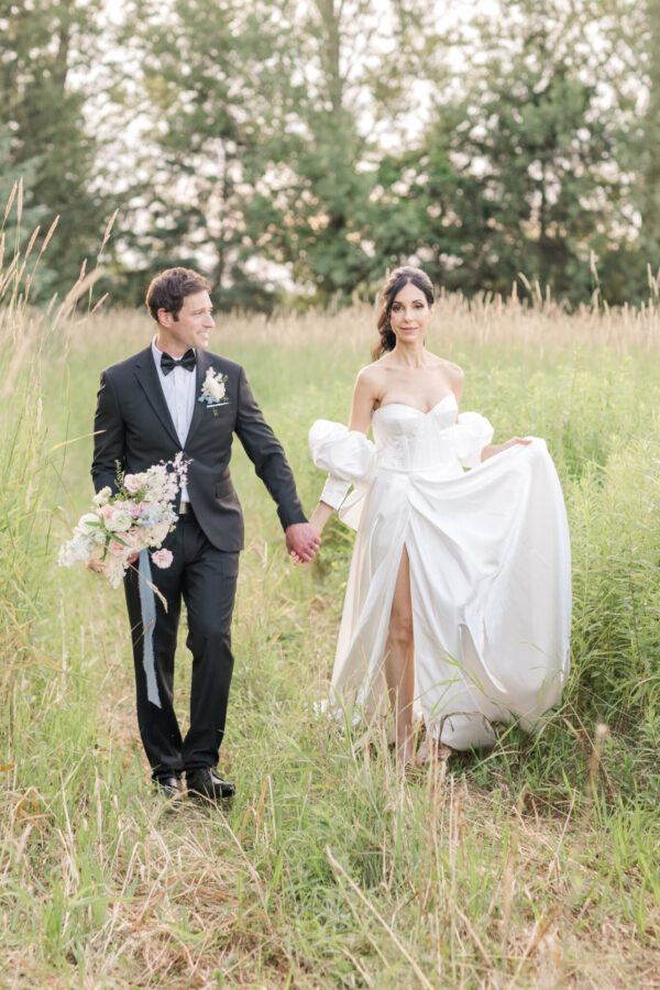 a wedding couple in a field with flowers