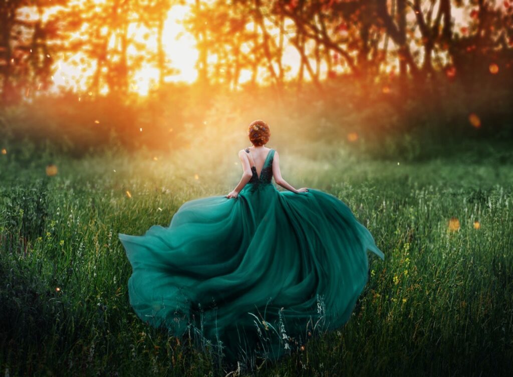 bride wearing colourful wedding dress in emerald green running through field