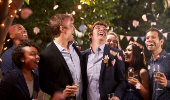 grooms celebrating their surprise wedding with guests.