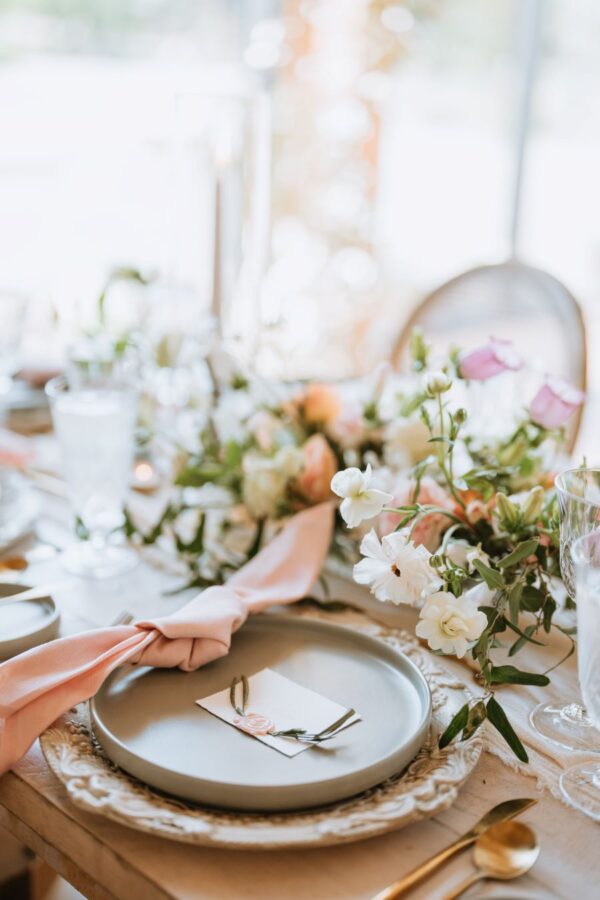 a table setting adorned with delicate pink and white flowers