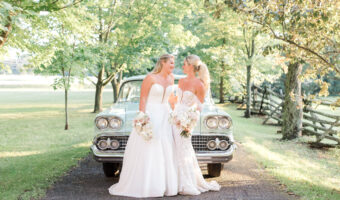 Cassidy and Dayna pose in fron of vintage car.
