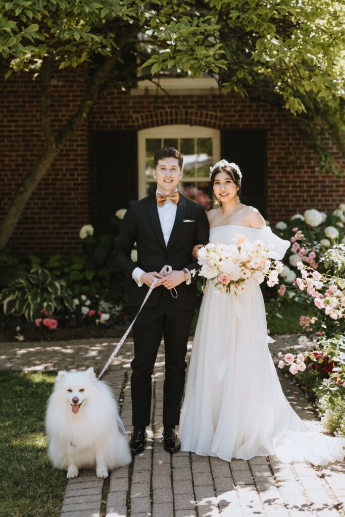 bride and groom pose with dog