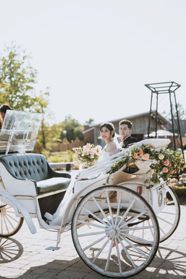 wedding couple in a white carriage