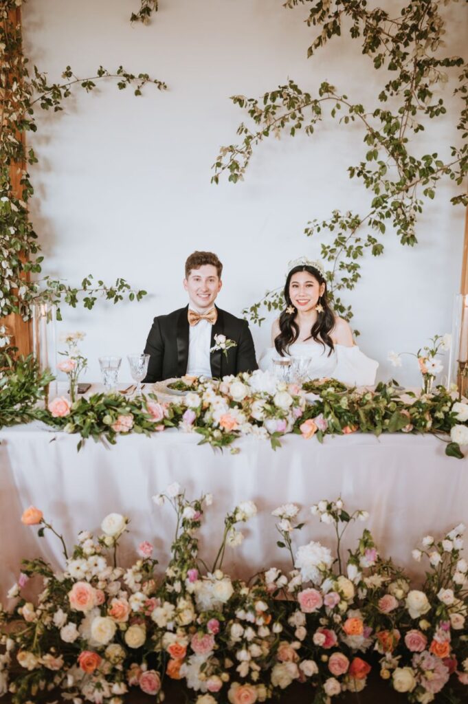 Wedding couple amidst floral decor