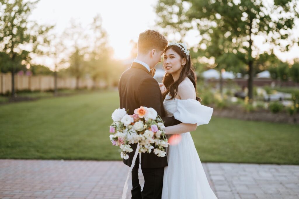 a groom and a bride with white flowers
