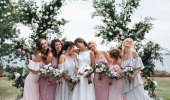 Bride and her bridal party ouside wearing mix matched bridesmaid dresses