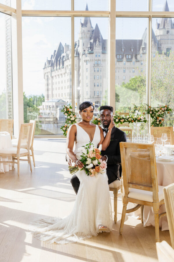 stunning photo of bride and groom at modern wedding at the National Arts Centre Ottawa floor to ceiling window backdrop for bride and groom portrait