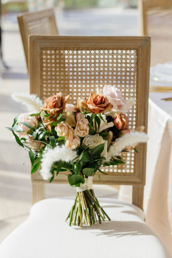 Beautiful wedding bouquet resting on a chair.