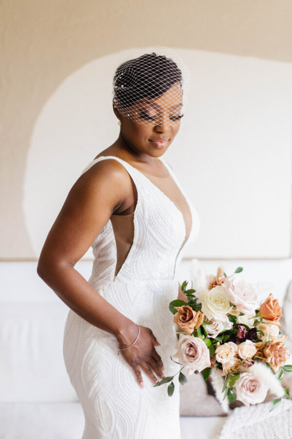 A stunning bride in her wedding gown and veil, radiating joy and elegance on her special day.