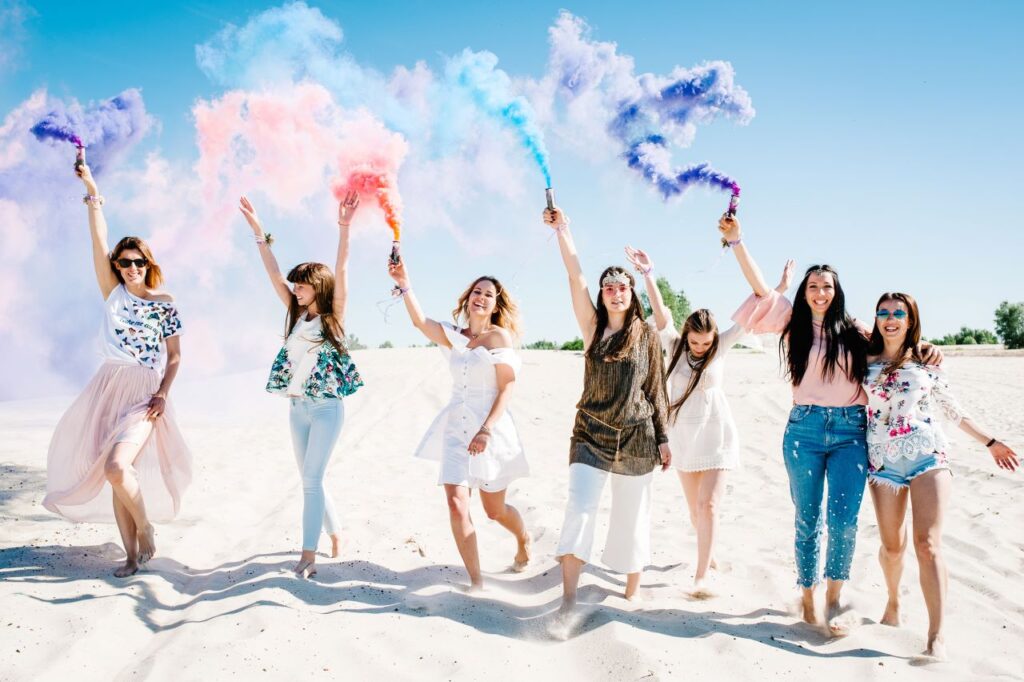 destination bachelorette party photography with smoke bombs on the beach