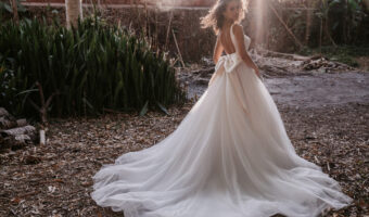 stunning golden hour image of bride outside wearing low back A line wedding dress with oversized ow