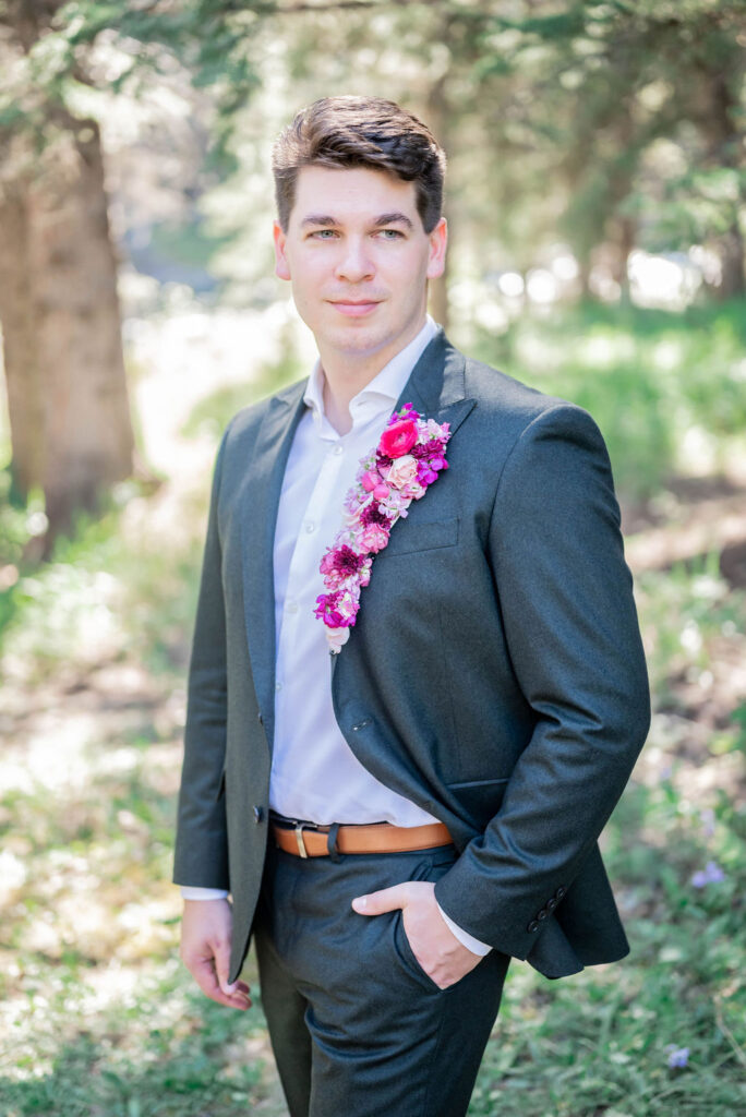 Groom sporting pink floral lapel for Barbie-styled wedding shoot