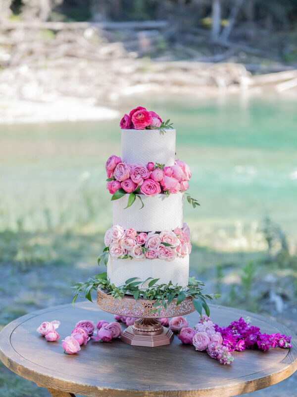 pink flowers on white wedding cake riverside at styled wedding