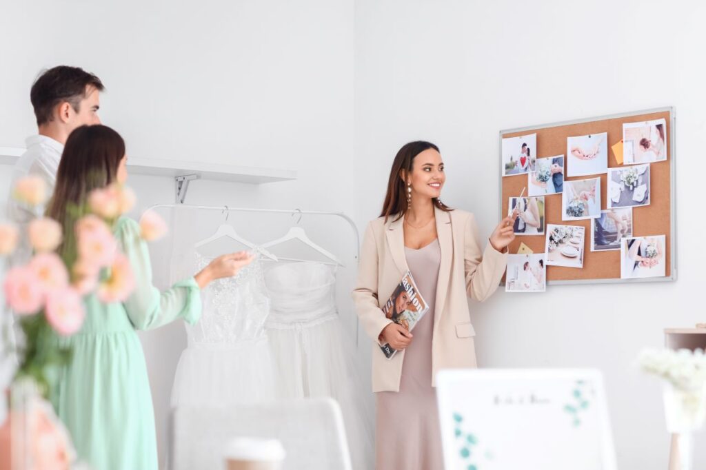 bride and groom meet with wedding planner in office to work out ceremony details