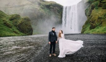 the perfect elopement image of bride and groom near Skogafoss Waterfall in Iceland