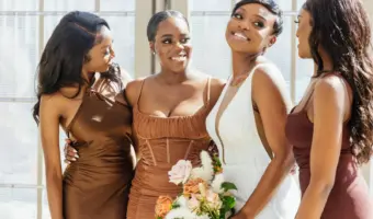 introverted bride poses with bridesmaids