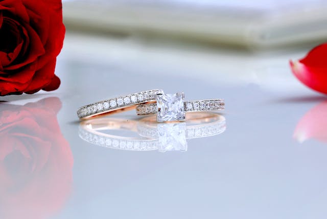 diamond wedding band and engagement ring on table