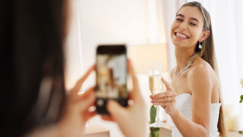 bride poses with glass of champagne for wedding content creators photo
