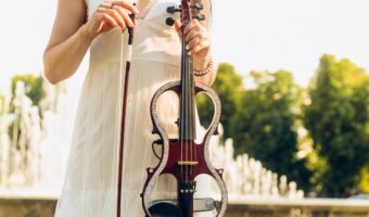 woman standing holding an electric violin a trending innovative wedding ideas