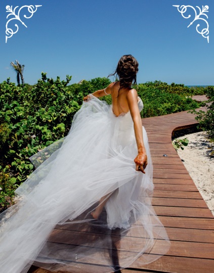 bride running down boardwalk to beach at destination weddings